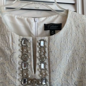 Ivory shift dress with beaded details.